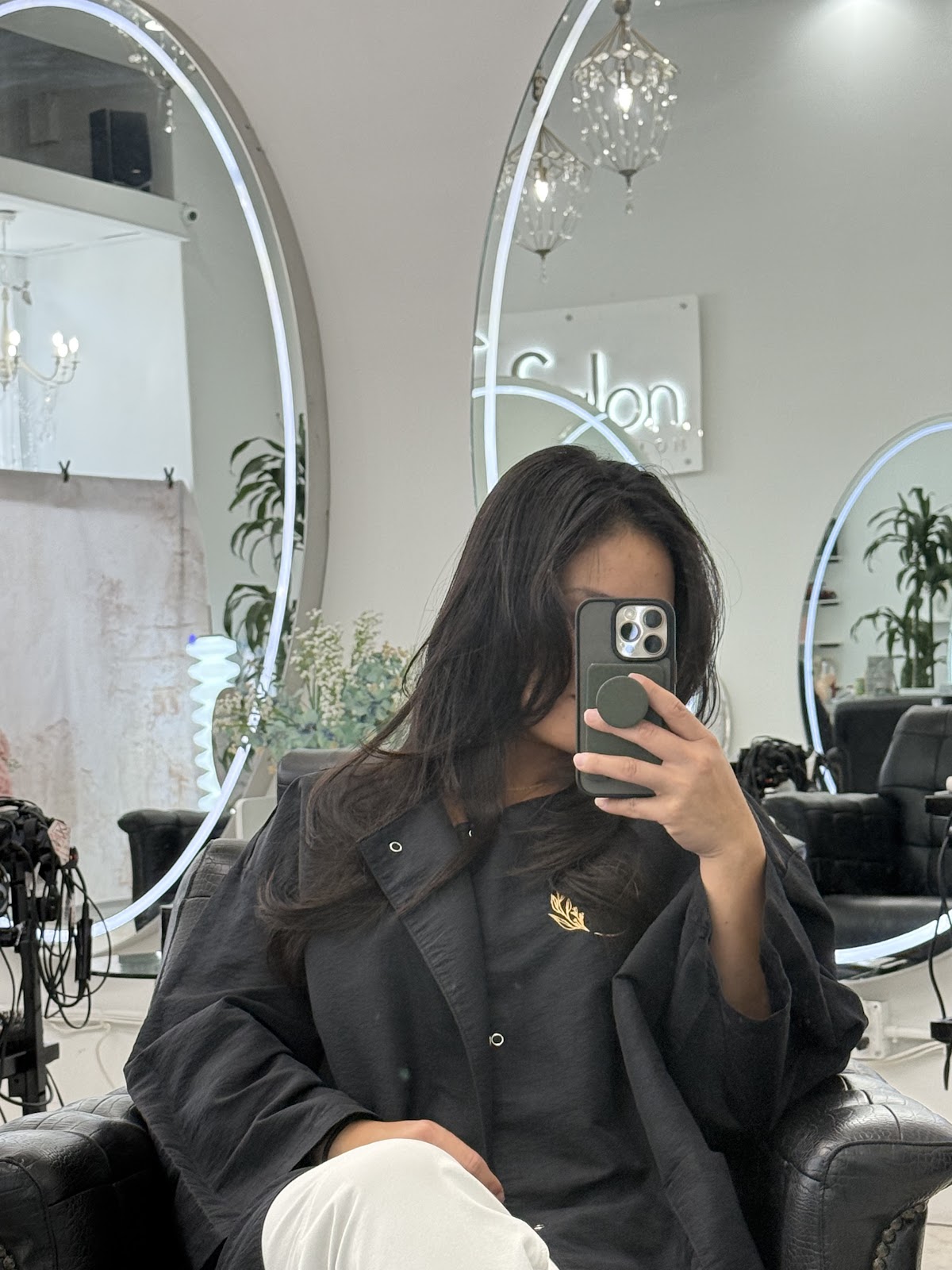 Mirrors and the neon K Salon sign inside the salon