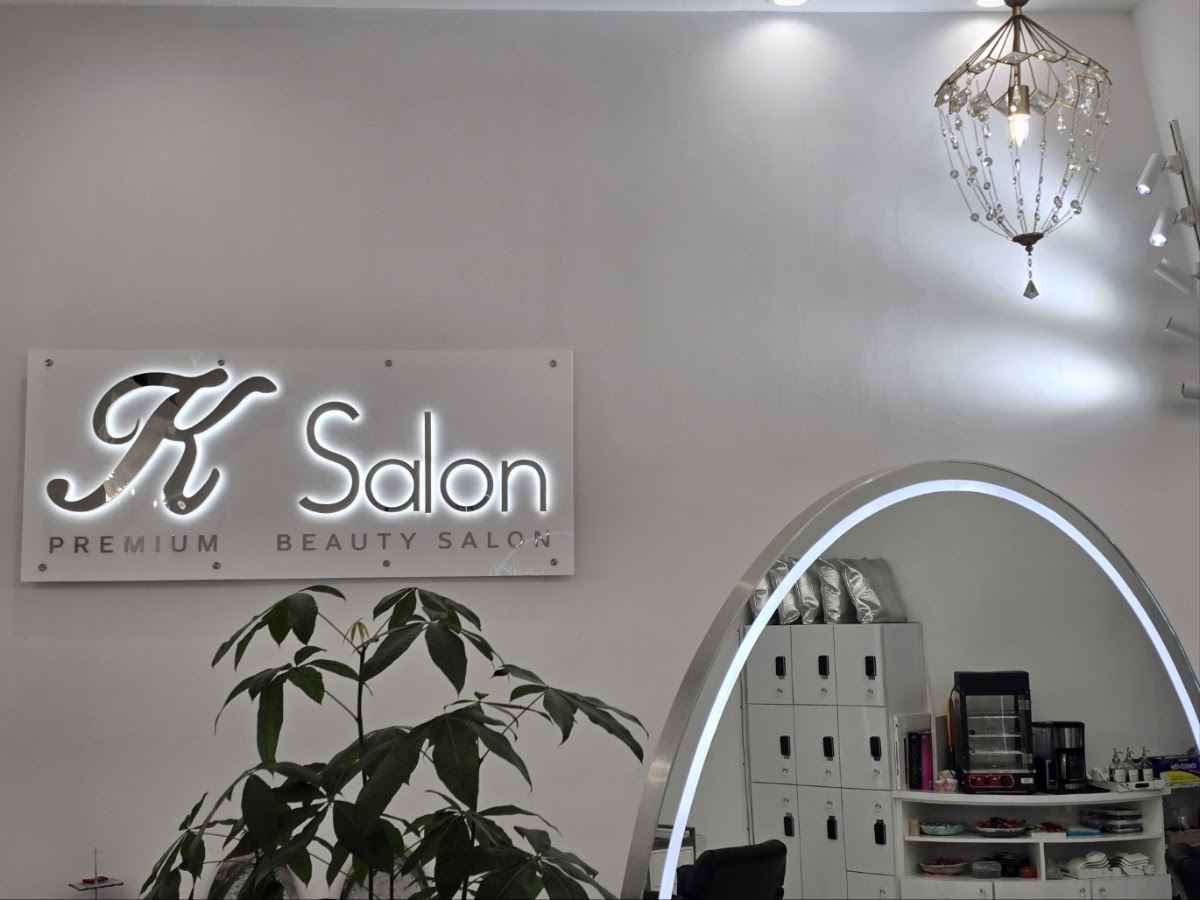 The K Salon sign inside the salon, reading Premium Beauty Salon